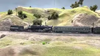 Southern Pacific Owl heavyweight sleeper train crawling uphill with the help of an AC-2 pusher