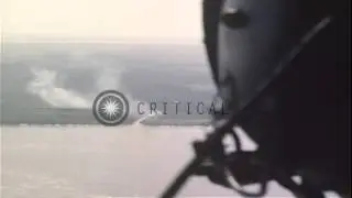 Waist gunners fire machine guns from a Seawolf helicopter at a Viet Cong territor...HD Stock Footage