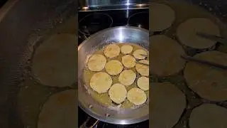 My Italian Nonna's Fried Zucchini  on a stainless steel pan