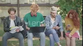 Four Concentrated University Students Surfing Internet and Doing Homework on Campus. Portrait of...