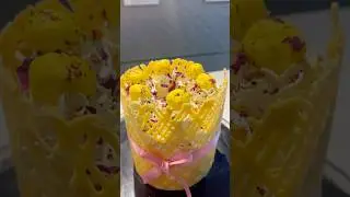 Yellow lattice cake topped with cream swirls, boondi balls, rose #tieredcake #moderncake #viral