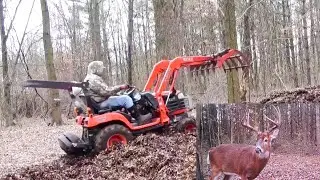 Kubota BX---grapple stirring the hot-cored, deranged-animal hangout.
