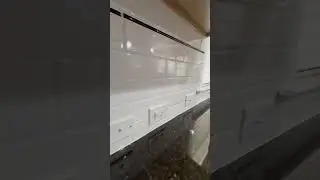 Newly installed white subway backsplash tile