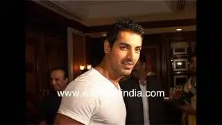 John Abraham wears a tight fitting T-shirt and blue jeans to Shahrukh Khan's book launch