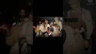 Royal Saudi Navy officers assist a child onboard their ship as they evacuate Saudis