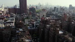 Aerial view of Manhattan's bustling cityscape, featuring iconic skyscrapers and the Hudson River