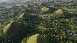 Beautiful drone view of chocolate hills at sunset Bohol province and numerous hills 4K