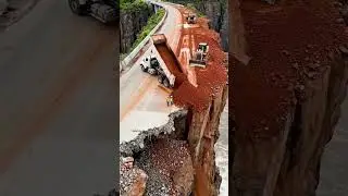 Filling the area where the road was damaged by an earthmoving Dump truck and Bulldozer .
