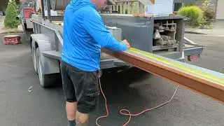 Rolling out copper colored metal oversized custom gutters