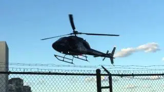 PRIVATE HELICOPTER MAKING A APPROACH & LANDING AT HELIPORT ON 34TH ST. IN KIPS BAY, MANHATTAN, NYC.