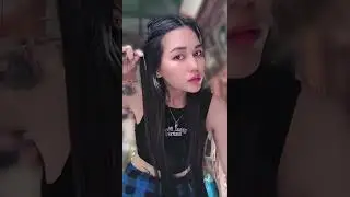 Cute and thick Myanmar girl wearing black tank top fixing her hair 