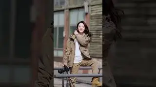They&rsquo;re wearing a stylish orange jacket, beige cargo pants, and tan boots, accessorized with a