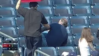 A fan makes a valiant effort for a foul ball