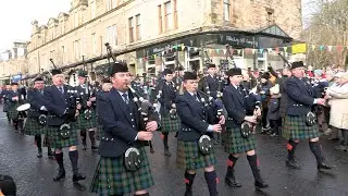The Vale of Atholl Pipe Band march in starting display for Pitlochry 2024 New Year Street Party