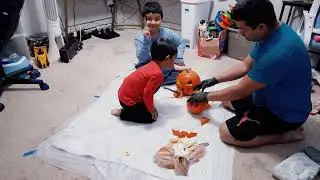Carving a face on a pumpkin with my dad