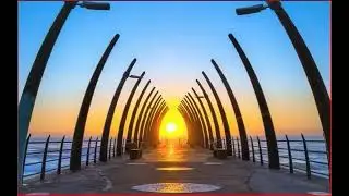 Whalebone Pier in Umhlanga, South Africa, where curved metal arches mimic whale bones framing the su