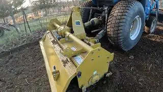 New Holland TC33D tractor using a rototiller 