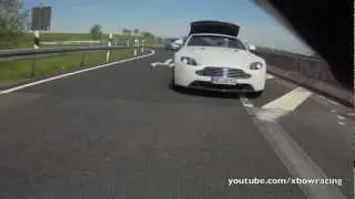 Aston Martin Vantage V8 Roadster opening roof while driving