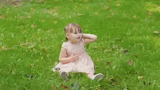 Mom and little girl walk in the park