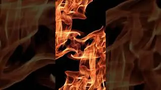 Dancing Flame: Orange Glow Against the Dark 4K
