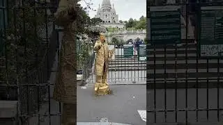 Gold man standing at entrance of Montmartre Paris