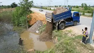 The Great Start project landfill flooded by dump truck unloading soil with bulldozer pushing soil 
