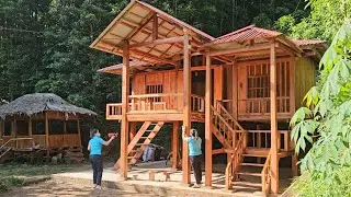 The girl built a wooden house, sprayed two coats of finishing paint and polish the wooden boards