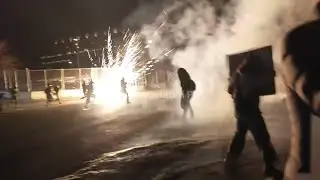 Federal agents toss flashbangs toward protestors outside federal building in Minneapolis