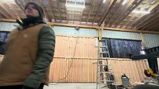 Installing upper garage door panel in shop 2 piece hanger style made of wood 