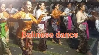 Balinese women and men dancing in a temple during a ceremony at the temple, Balinese Hindu tradition