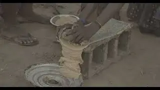 Mundari girl grinding peanuts on a stone, Central Equatoria, Terekeka, South Sudan