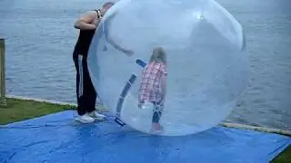 Jess going into the river in an inflatable ball