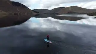 Fly over paddle boarder at St Mary's loch in Scottish borders