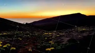 Experience the breathtaking beauty of a sunset illuminating the stunning mountain landscape