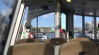 Water taxi on the Thames and several statues nearby.