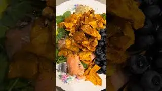blueberries￼, sweet potato chips, Norwegian salmon, mixed greens, hummus topped ￼roasted pine nuts