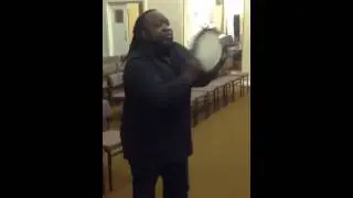 Pastor Patrick George playing the tambourine  UK