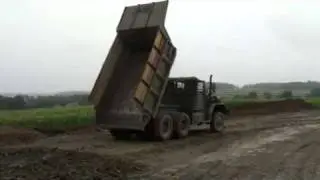 M51A2 Army dump truck dumping shale