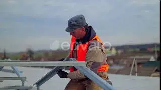 Worker attaches metal basis for solar panels | Stock Footage - Envato elements