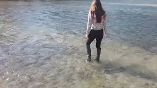 wet muddy Alberta Ferretti knee high leather boots in the river
