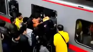 Guy Trying To Exit The Train Is Pushed Back Inside By Crowd