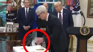 Apple CEO Tim Cook gets nervous and his hand trembles when giving Trump gift