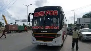 Mash Poa Bus glides down the road, a symphony of motion on wheels.