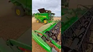 John Deere X9 1100 combine harvester with 45 foot draper header working in wheat
