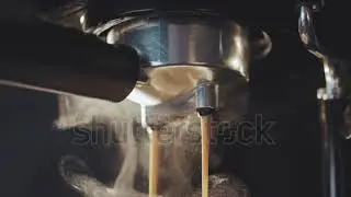 stock footage pouring coffee stream from professional machine in cup barista man making double espre