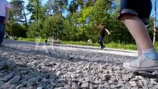 Group of school kids performs sports motivational greeting with hands on playground of yard football