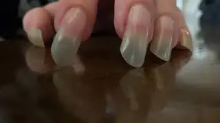 Long Natural Fingernails Tapping in Boredom on Granite Countertop