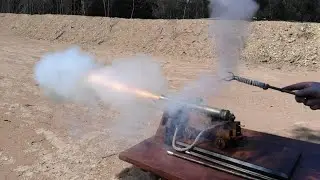The firing of an eighth scale model English 12 pounder naval gun.