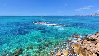 Aerial video shows serene turquoise ocean and rocky formations
