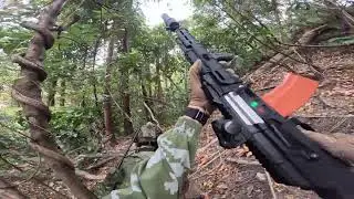Man plays pretend in the woods with his friends 